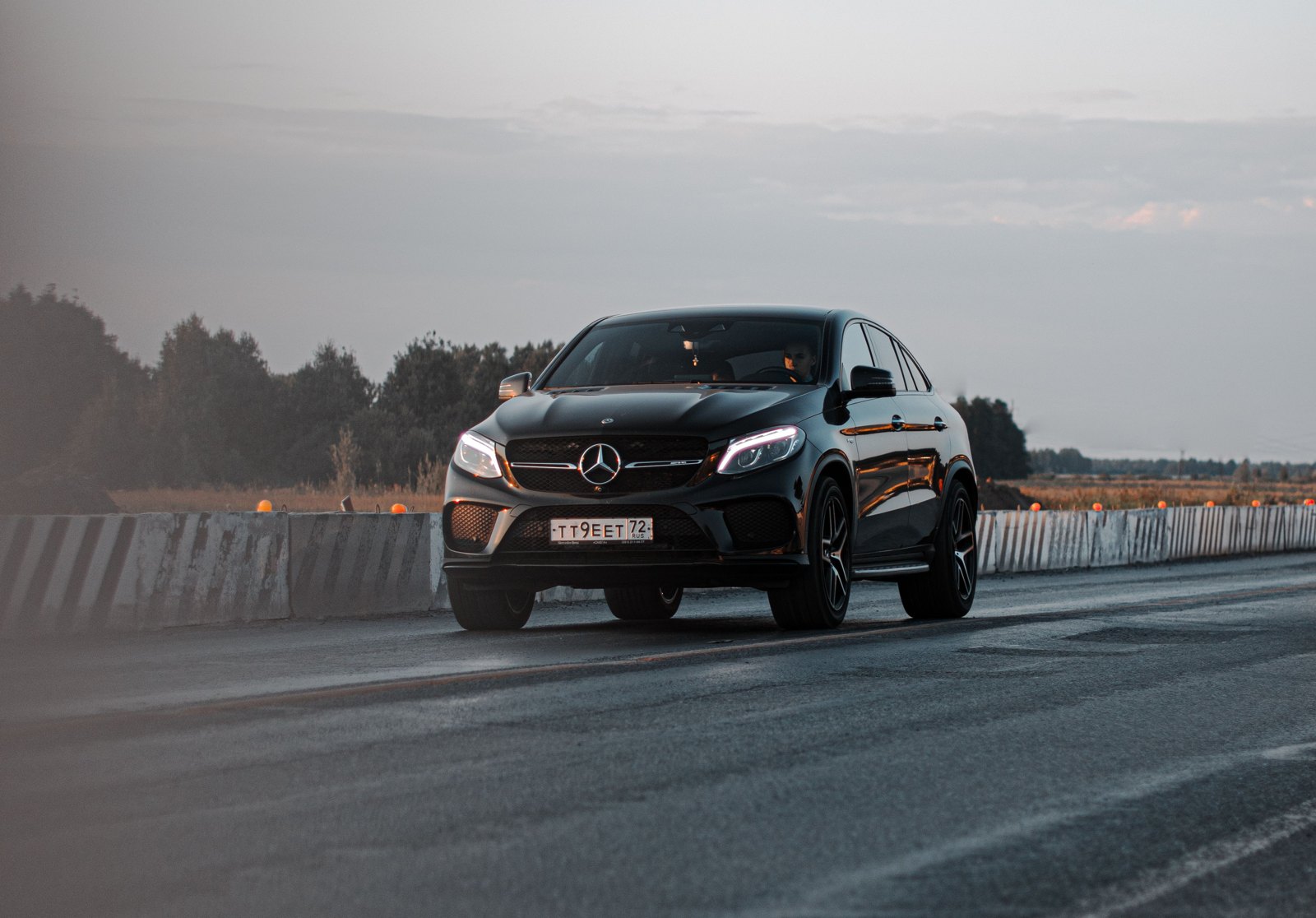 A premium black car parked on an open road