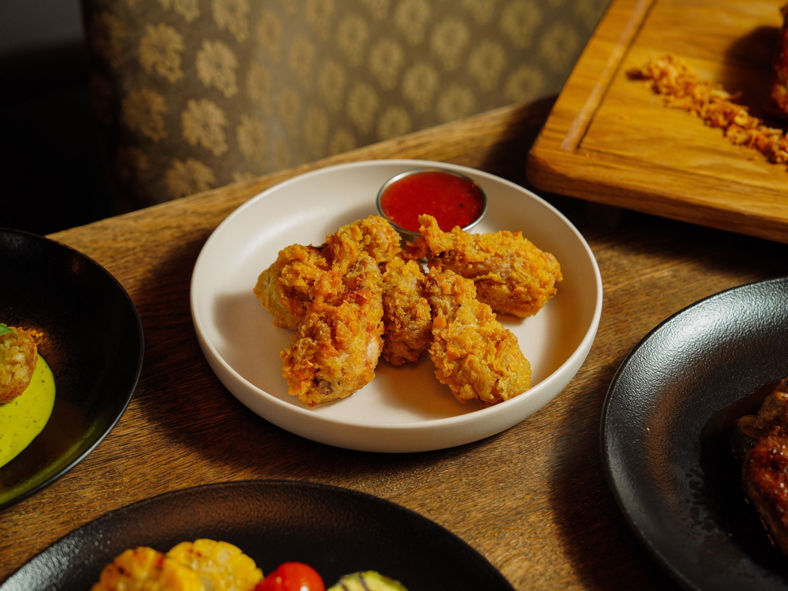 Crispy fried chicken served with a dipping sauce